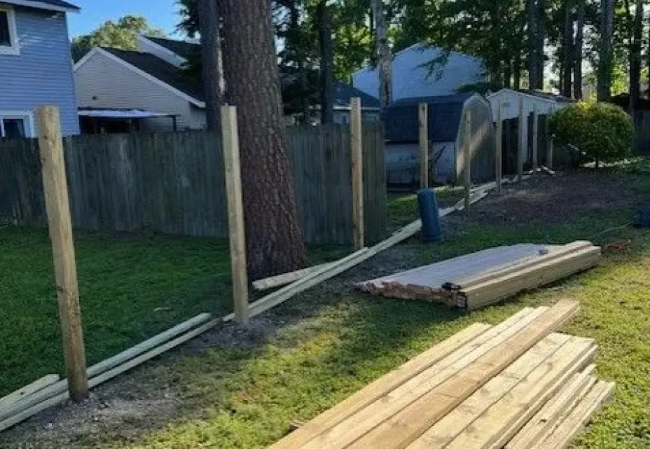 Wooden fence installation in progress