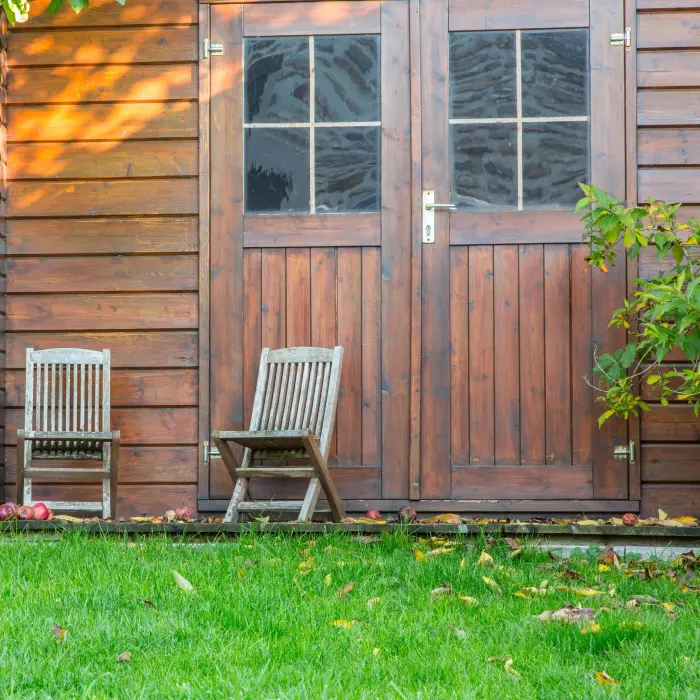 Wooden garden shed with chairs