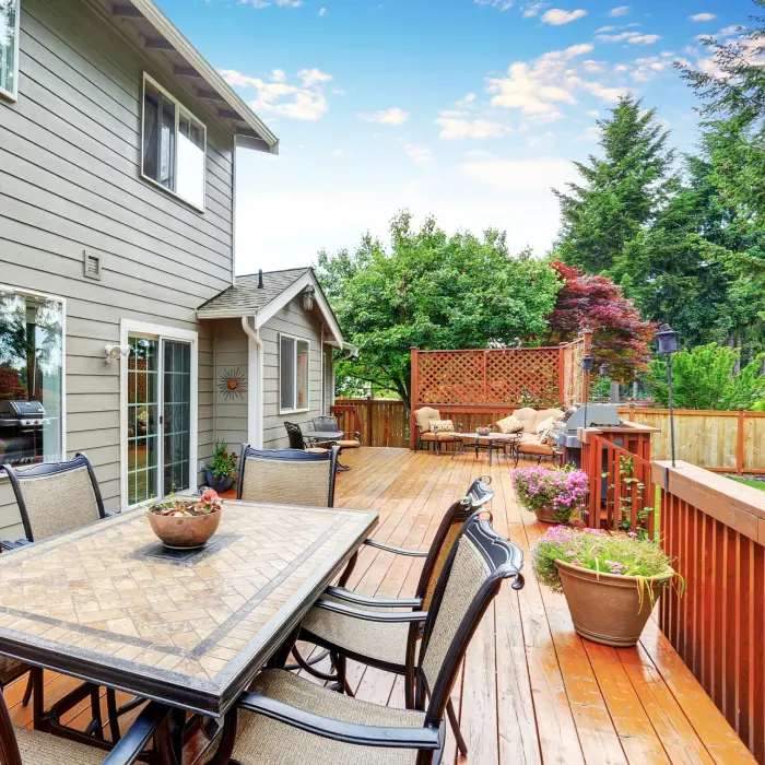 Spacious backyard deck with furniture